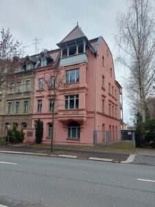 Mehrfamilienhaus mit rosa Fassade