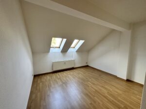 Wohnzimmer mit Laminat und 2 Dachliegefenstern, Dachräge und Heizkörper